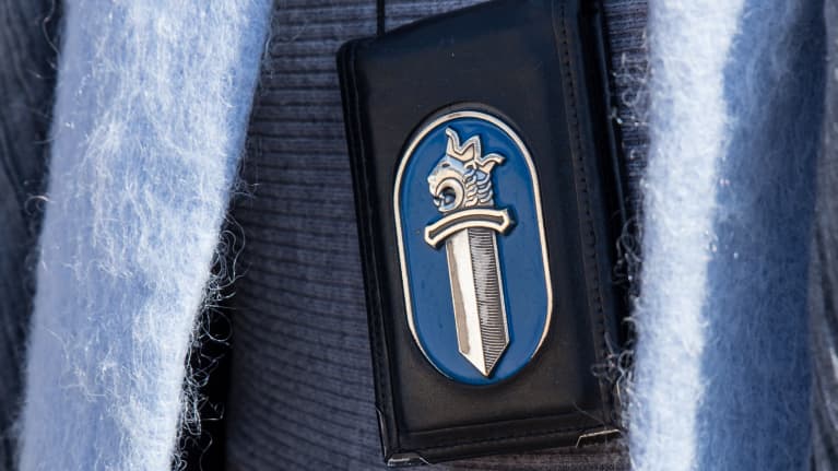 Poliisin kaulassa roikkuva lätkä. 