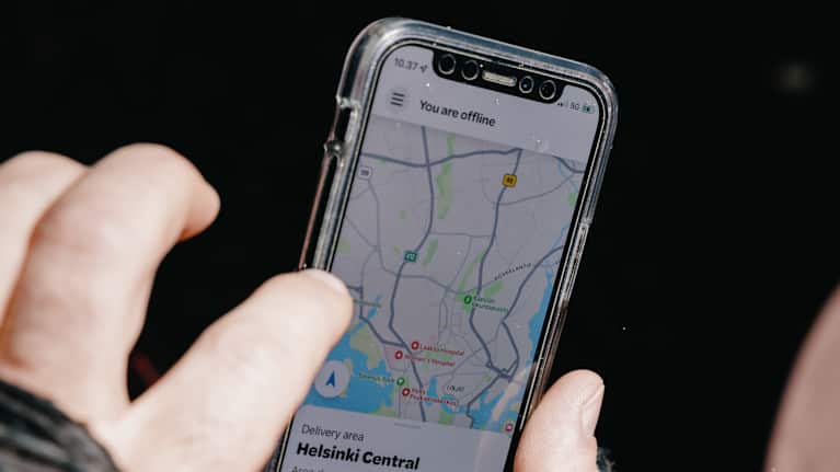 Wolt food deliveryman Timur scrolls through his phone.