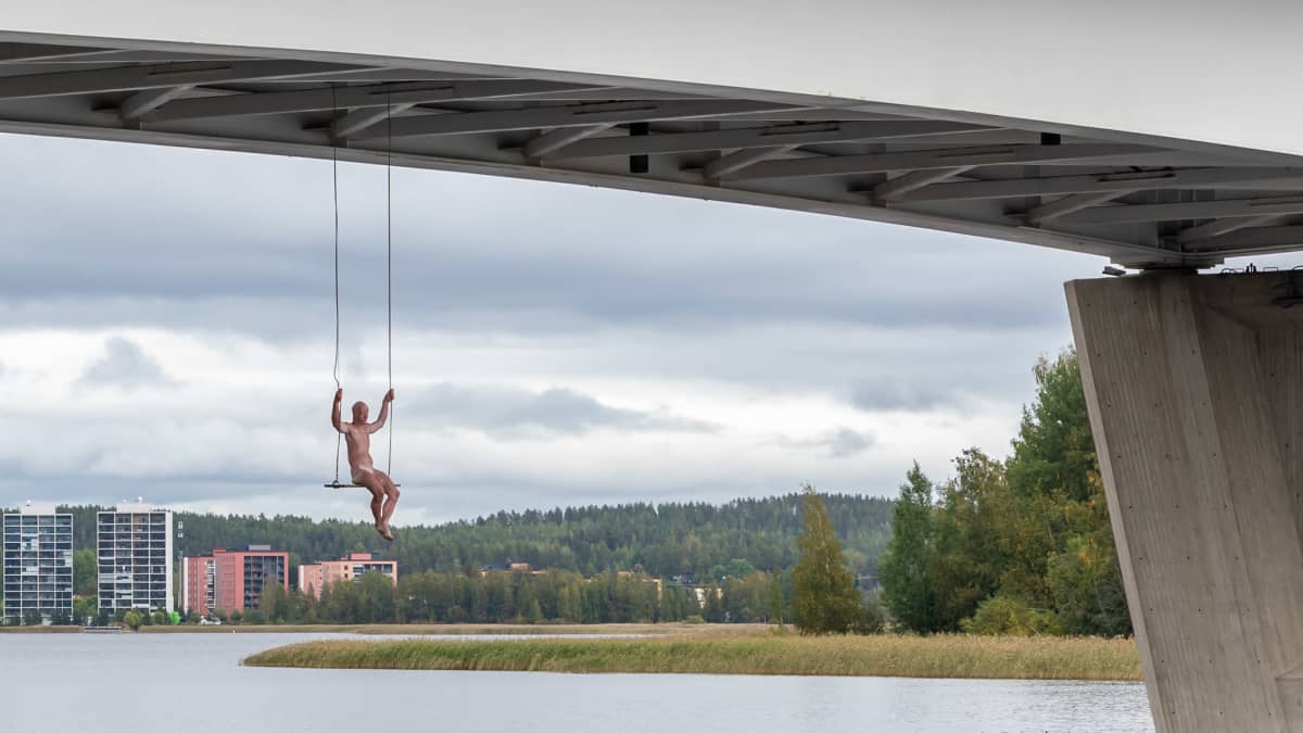 Photo shows the artwork, known as the 'Swinger' hanging under Kuokkala bridge in the city of Jyväskylä.