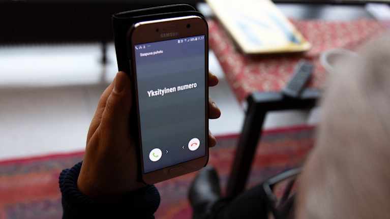 The woman looked at her phone and it said 