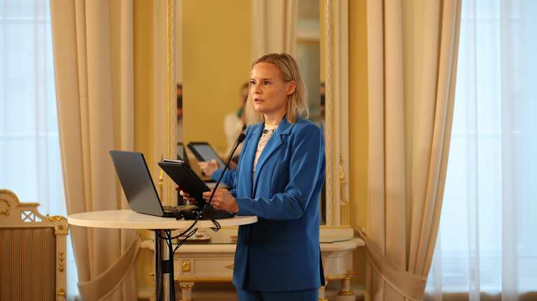 Riikka Purra speaking at a seminar.