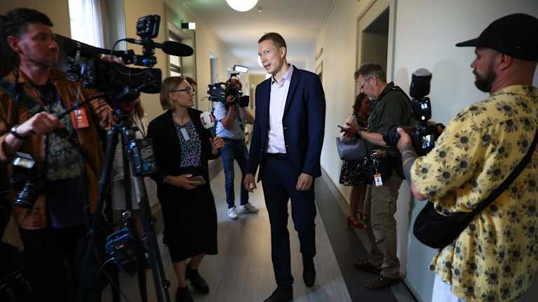 Photo shows Social Democratic Party MP Ville Merinen speaking to reporters in Parliament on Thursday.