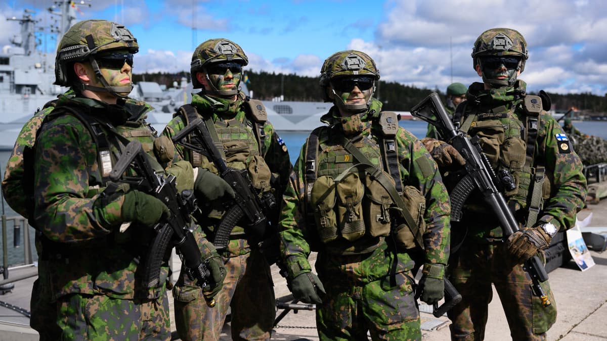 Four Finnish soldiers getting prepared for training.
