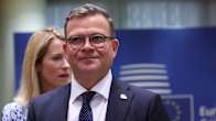 Finnish Prime Minister Petteri Orpo , with Estonian Prime Minister Kaja Kallas in the near background, with a blue European Council banner behind both of them.