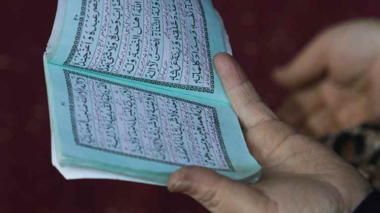 Woman reading the Quran.