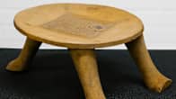 A three-legged wooden stool. 
