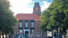 Lahden kaupungintalon remonttityömaa on lähikuvassa. Talon edustalla on työkoneita.