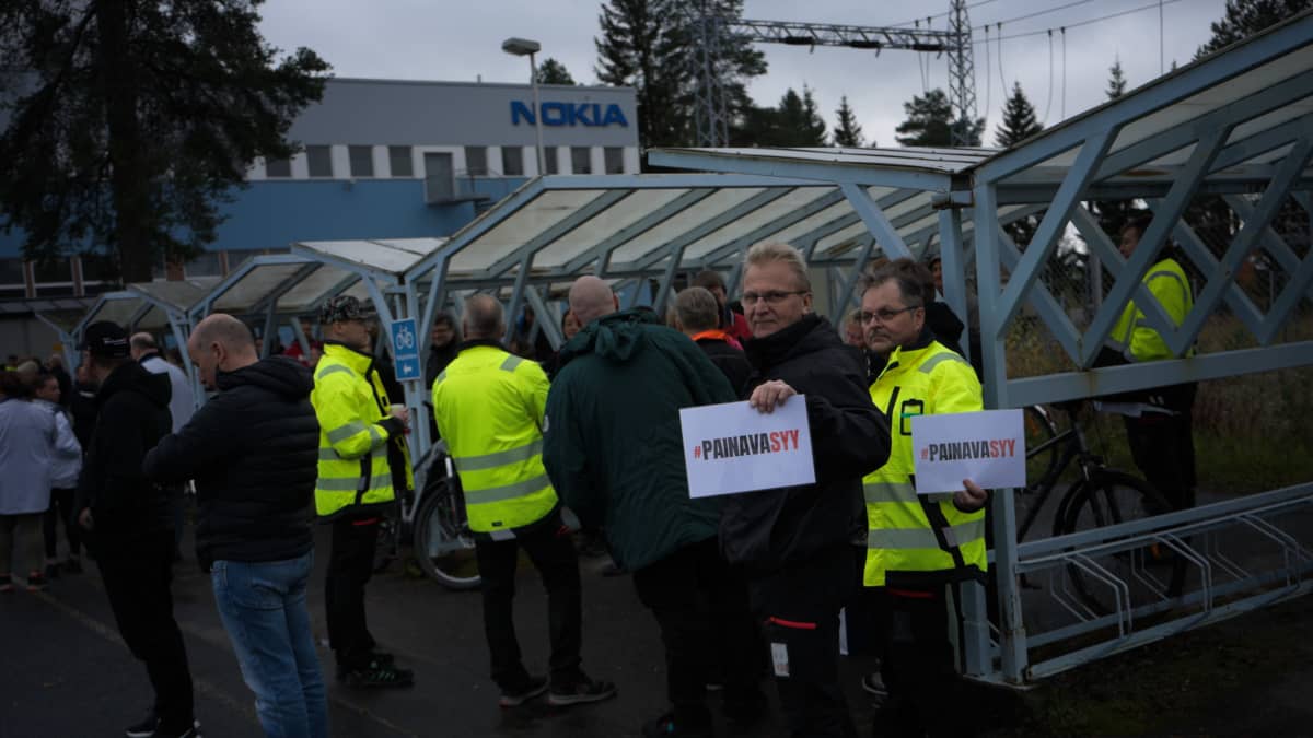Ulosmarssineet työntekijät seisovat ulkona Nokian yksikön pihalla Oulussa.