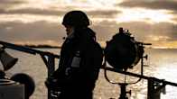 A sailor in battle gear on deck..