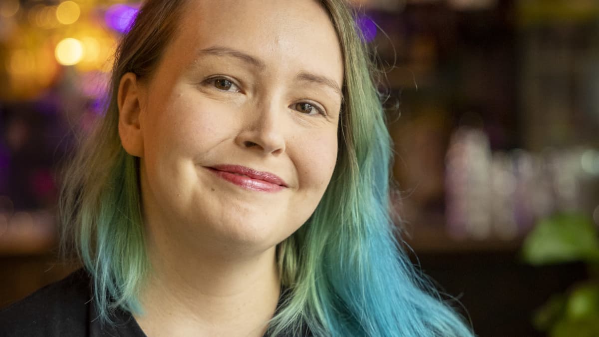 Anna-Elena Pääkkölä hymyilee baarissa.