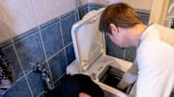 Man loading a washing machine with clothes.