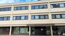 Lähikuva ulkoa Heinolan kaupungintalosta. Vaaleanruskea tiilinen rakennus