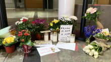 Photo shows candles and flowers marking the spot where the woman died in the Iso Omena shopping centre