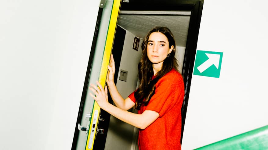 Henkilö pukeutuneena punaiseen neuleeseen.