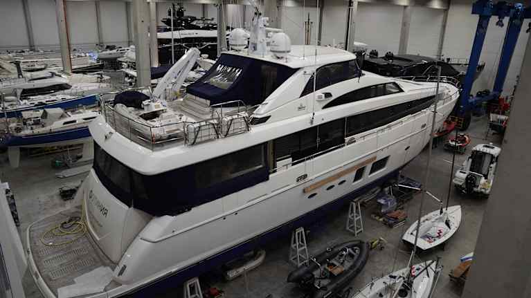 A white luxury yacht in storage.