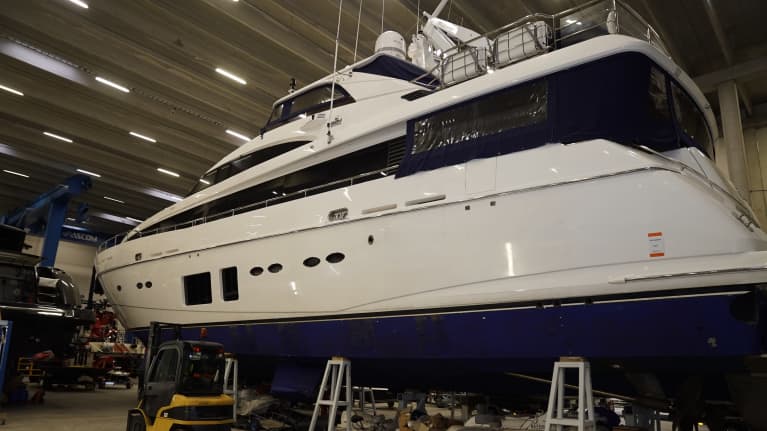 A white yacht in storage.