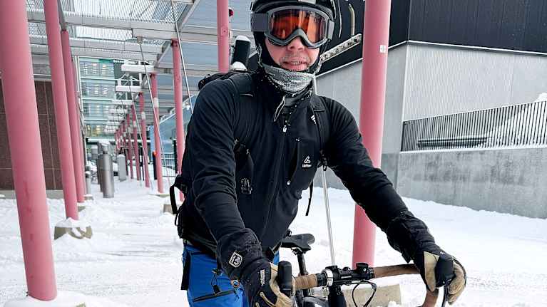 Person in winter gear with bicycle.