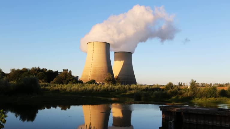 Kaksi ydinvoimalan jäähdytystornia, joista nousee höyryä ilmaan joen varrella Belleville-sur-Loiressa Ranskassa.
