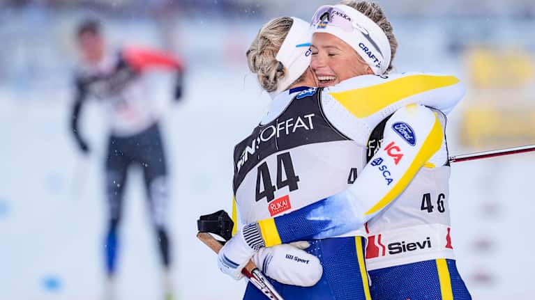 Image 12: Frida Karlsson hugging a teammate.