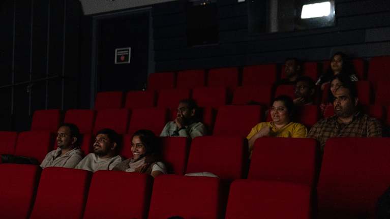 Moviegoers in a dimly-lit cinema.
