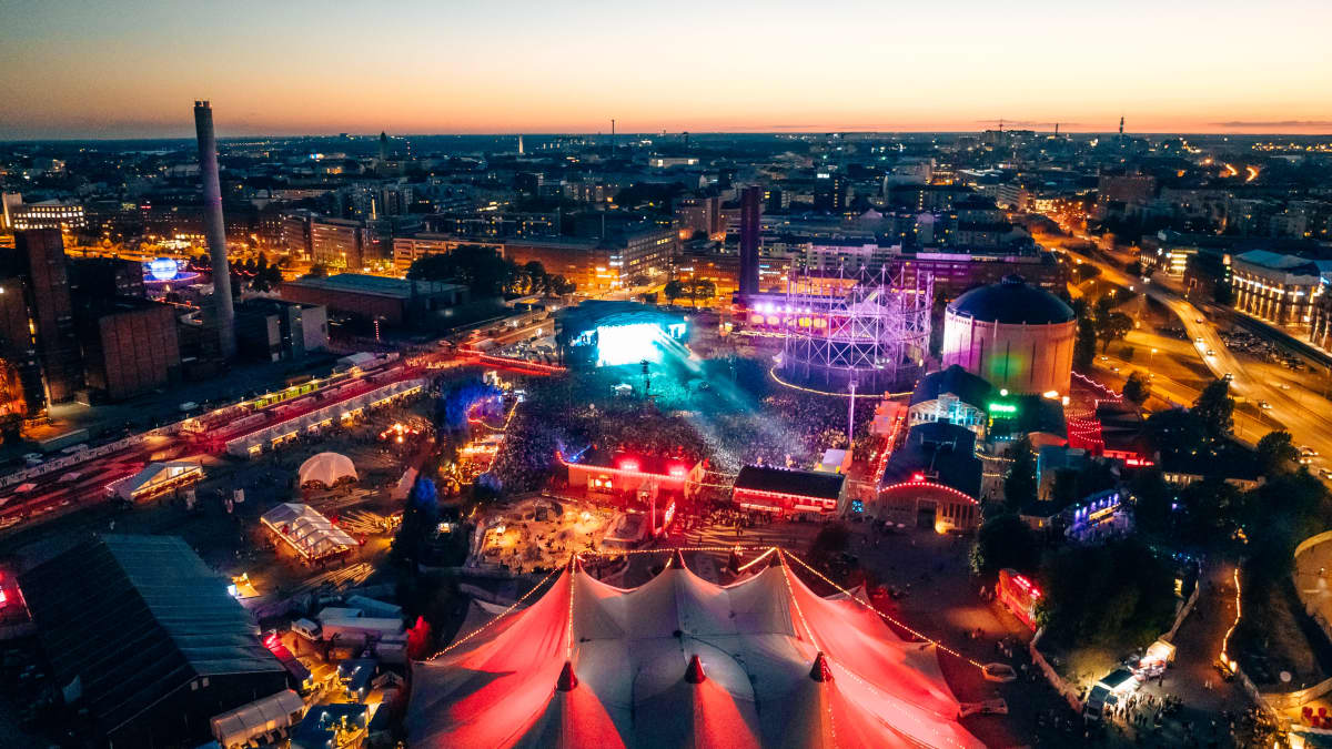 Nighttime aerial photo of Helsinki's Flow Festival in 2022, featuring brightly coloured tents and stages.