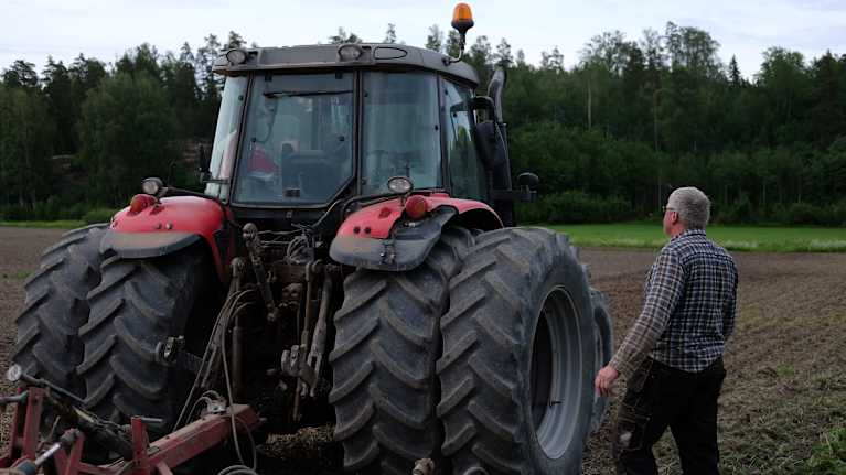 Stefan Forsman går fram till sin traktor.