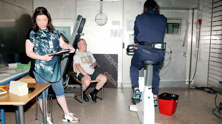 A man is pedaling an exercise bike. 