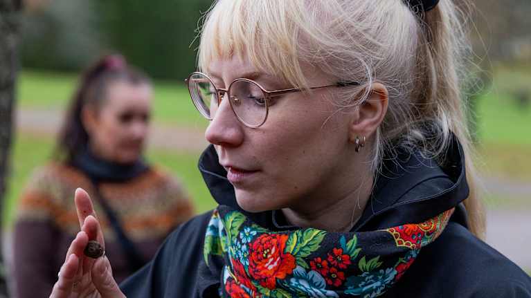Monica Alt, who is researching truffles, looks at the truffle in her fingers.