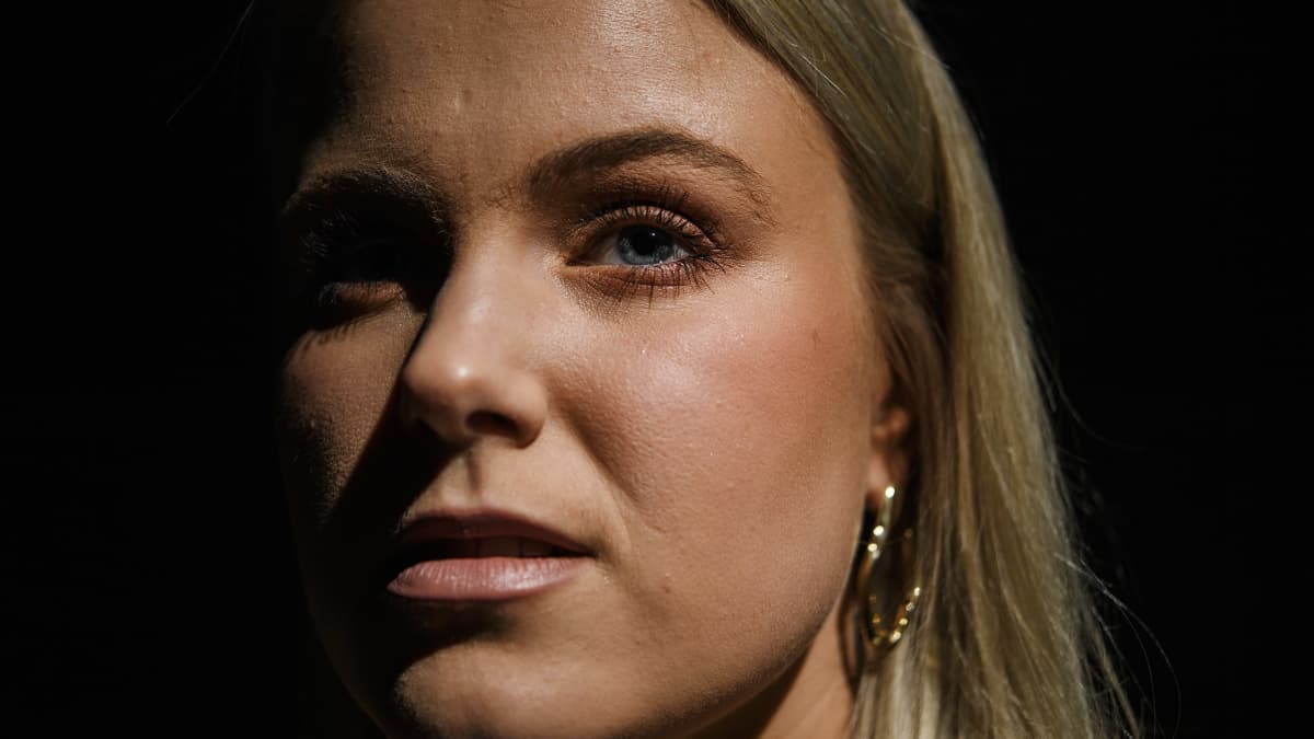 Kirjoittaja Nea Lundström poseeraa tummasävyisessä henkilökuvassa.