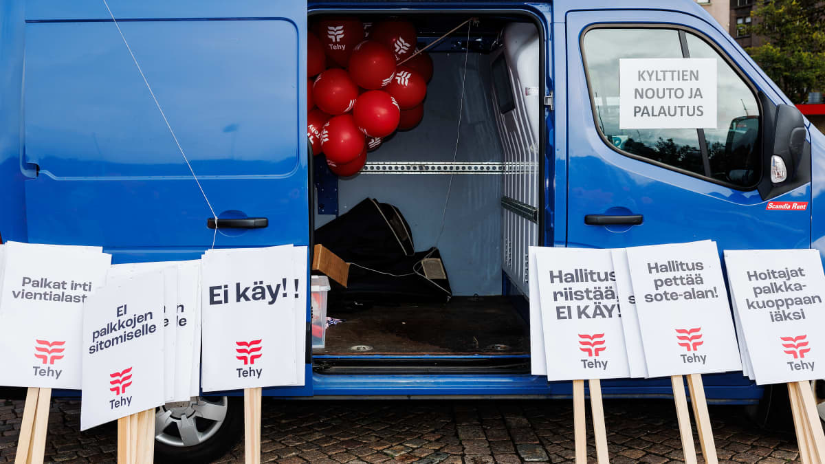 A Tehy van, door open, with placards for protesters to collect