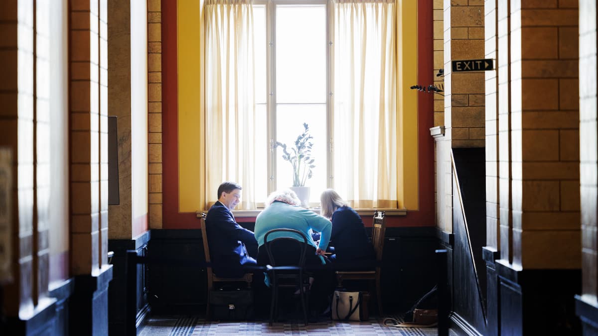 Thomas Blomqvist keskusteli kahden henkilön kanssa Säätytalon aulassa.