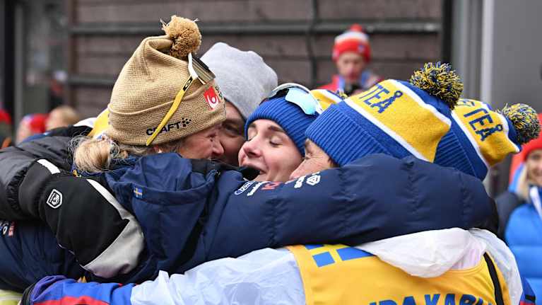 Image: Sweden's team hugs Karlsson after her victory.