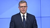 Finnish Prime Minister Petteri Orpo stands behind a podium.