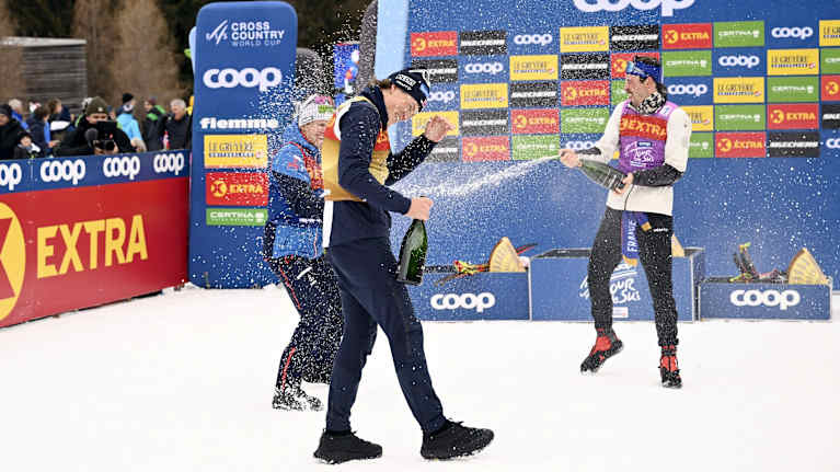 Mika Vermeulen, Hugo Lapalus, and Johannes Høsflot Klæbo celebrating with champagne after the Tour.