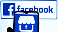 In this photo illustration, the Marketplace by Facebook icon is seen displayed on a smartphone screen with the Facebook logo in the background.