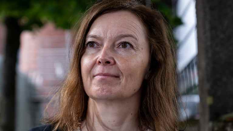 Eva Hinds standing next to the fence.