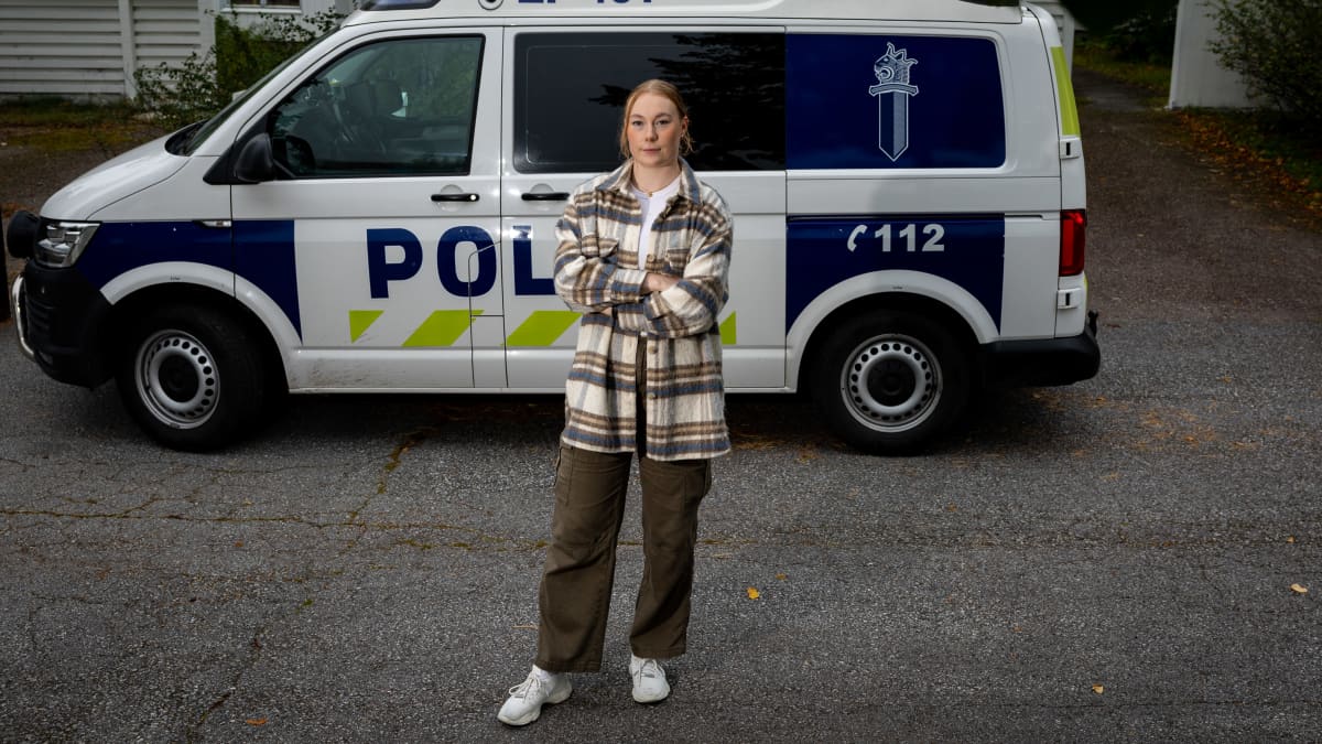 Poliisiopiskelija Ella Byman seisoo poliisiauton edessä.
