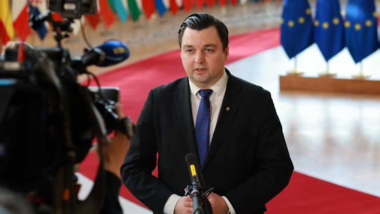 Photo shows Finland's Minister for European Affairs and Ownership Steering Joakim Strand (SPP) speaking to the media in Brussels.