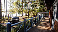 A photo taken from a waterfront summer cottage's porch.