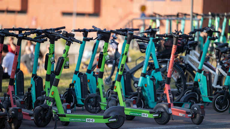 A group of electric scooters from different companies.