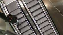 En person står i rulltrappan