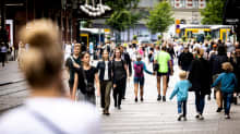 Photo shows people walking on the street in Helsinki.