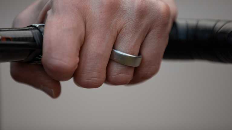 Photo shows a person's hand wearing an Oura smart ring.