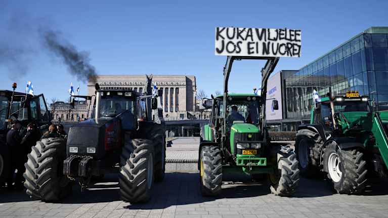 Photo shows tractors outside Parliament House.