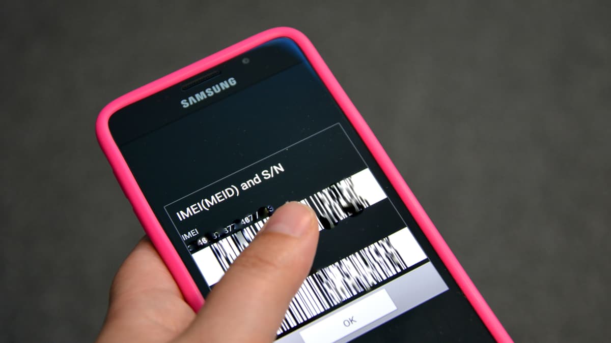 Smartphone displaying its IMEI number on the screen.