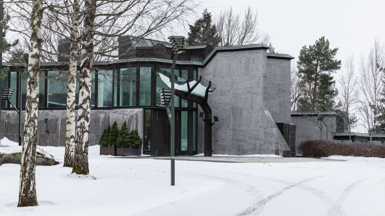 Exterior of Mäntyniemi, concrete house in winter.