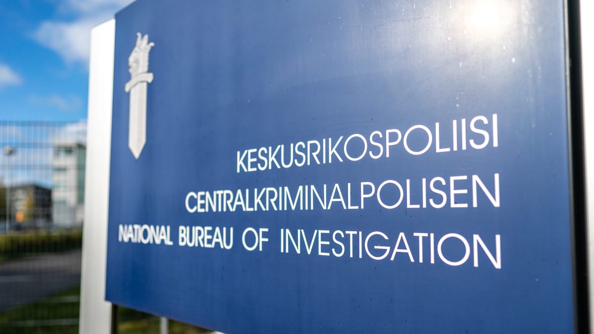 Blue sign with white text in three languages: National Bureau of Investigations. 