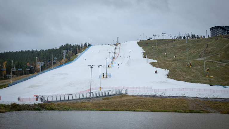 Snowy ski slope on dry land.