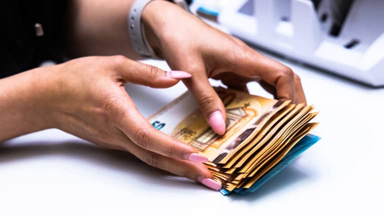 A person counting fifty euro notes.