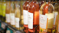 Alcohol bottles on the shelf of a retail store.